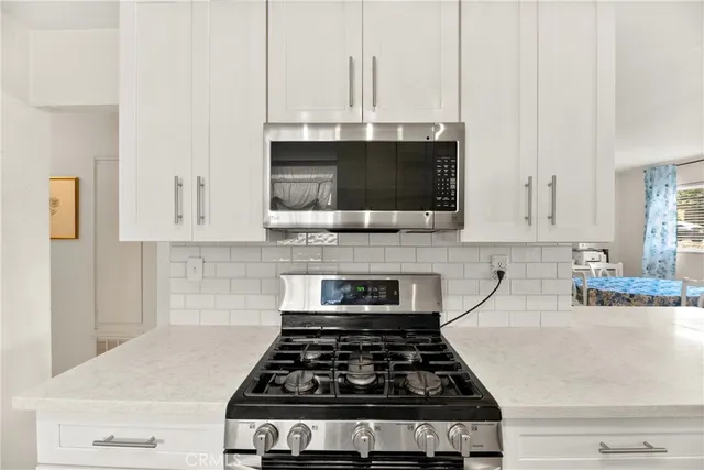a kitchen with sink a refrigerator and cabinets