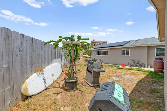 a backyard of a house with table and chairs