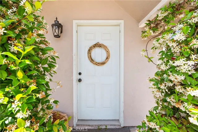 a living room with furniture a large window and a table