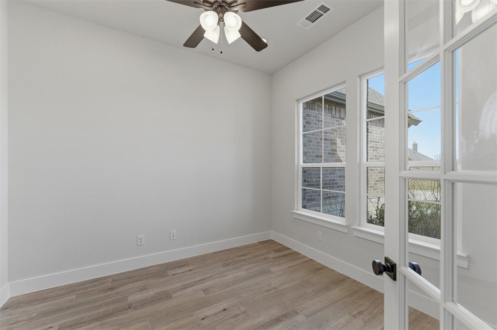 814 Vly Rdg Road Van Alstyne, TX 75495 - Photo 6 of 24 a view of an empty room with a window and wooden floor