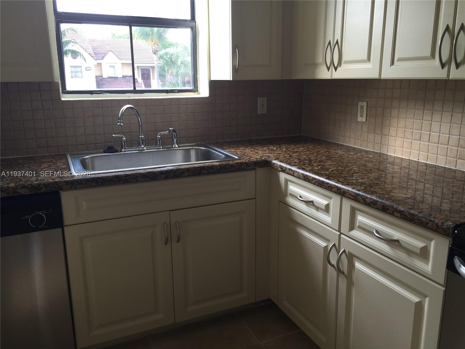 10441 Southwest 156th Court, Unit 421 Miami, FL 33196 - Photo 14 of 36 a kitchen with stainless steel appliances granite countertop a sink and dishwasher next to a window