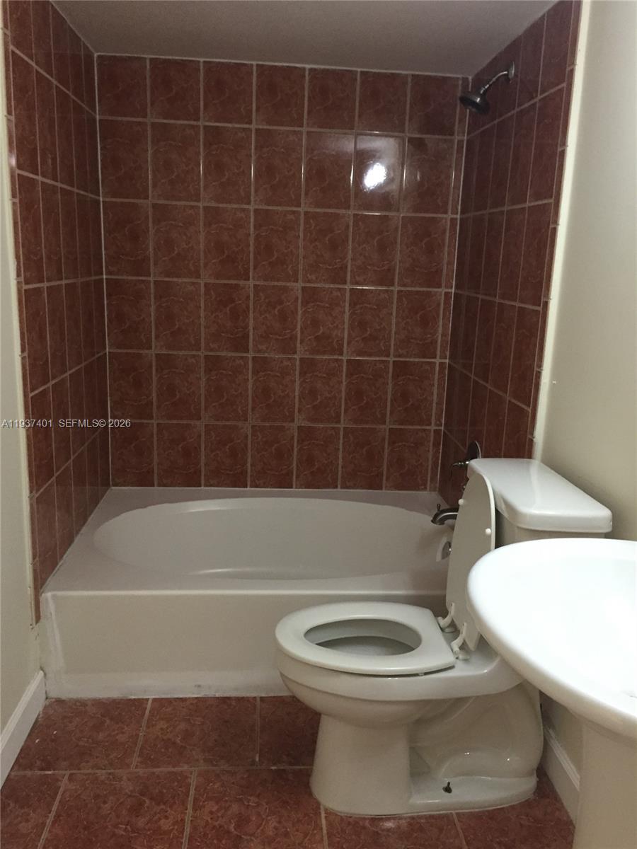 10441 Southwest 156th Court, Unit 421 Miami, FL 33196 - Photo 22 of 36 a bathroom with a toilet a sink and shower