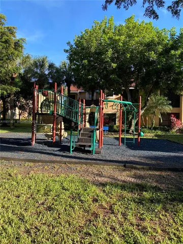 a view of a park with swings and slides