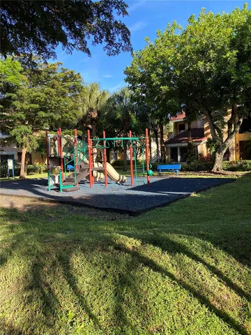 a view of a park with swings and slides