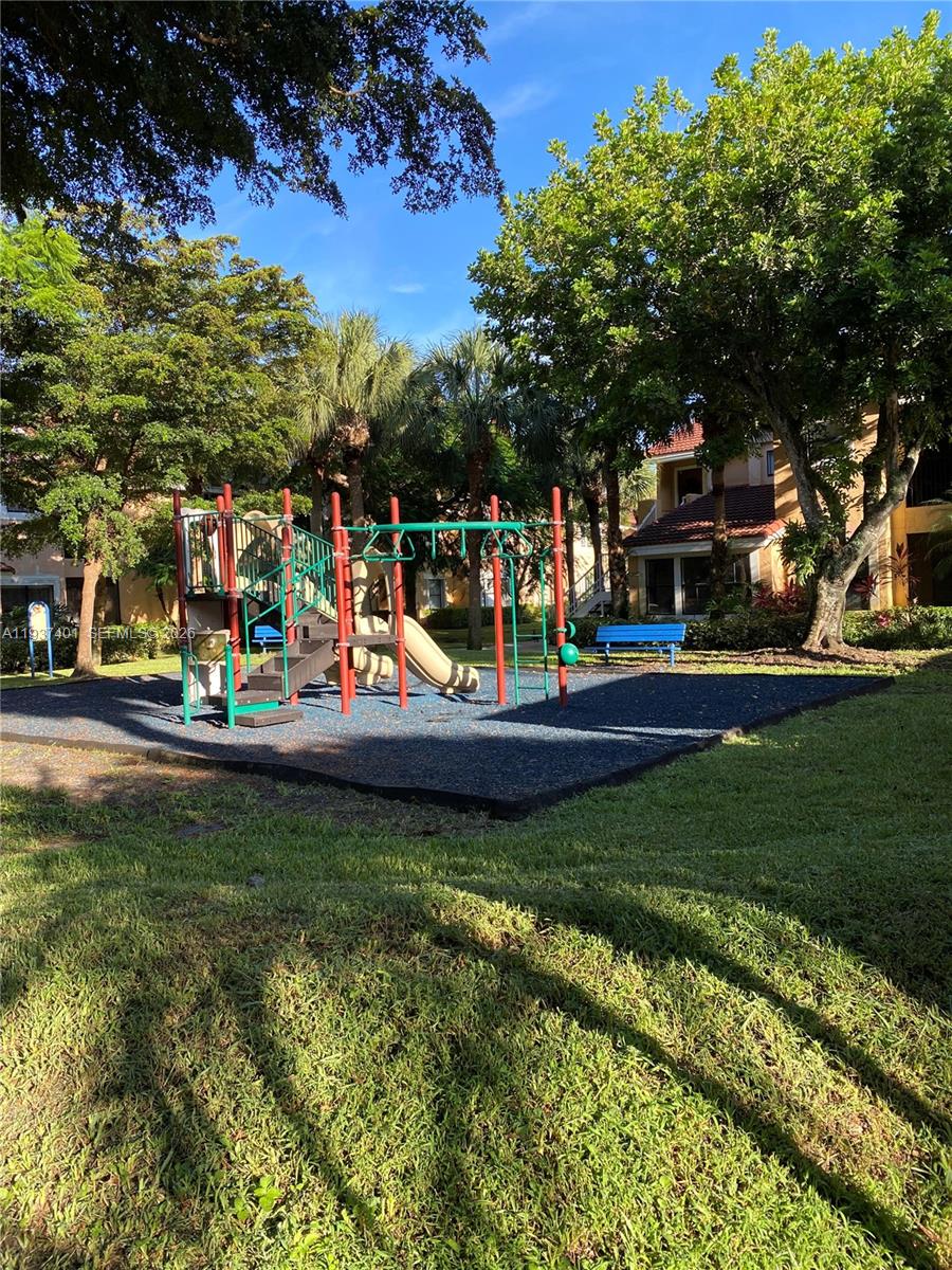 10441 Southwest 156th Court, Unit 421 Miami, FL 33196 - Photo 26 of 36 a view of a park with swings and slides