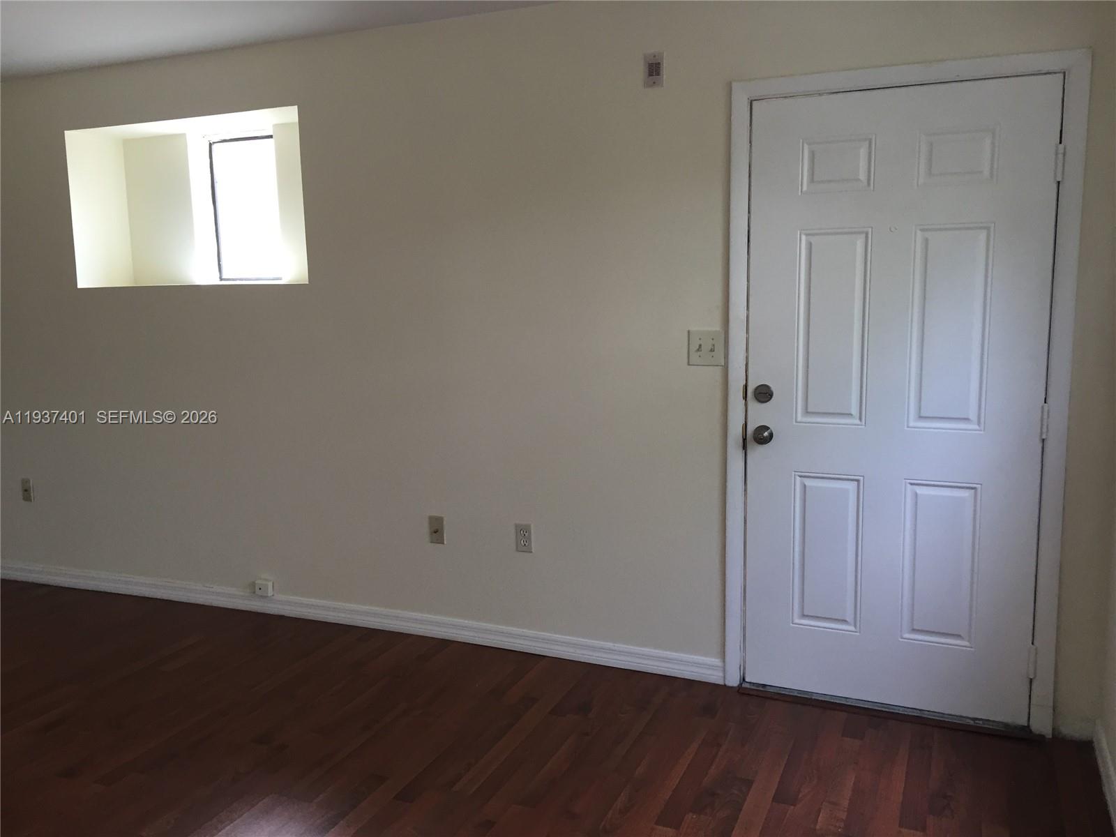10441 Southwest 156th Court, Unit 421 Miami, FL 33196 - Photo 3 of 36 an empty room with wooden floor and closet area