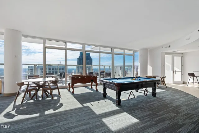 a living room with furniture a table and a large window