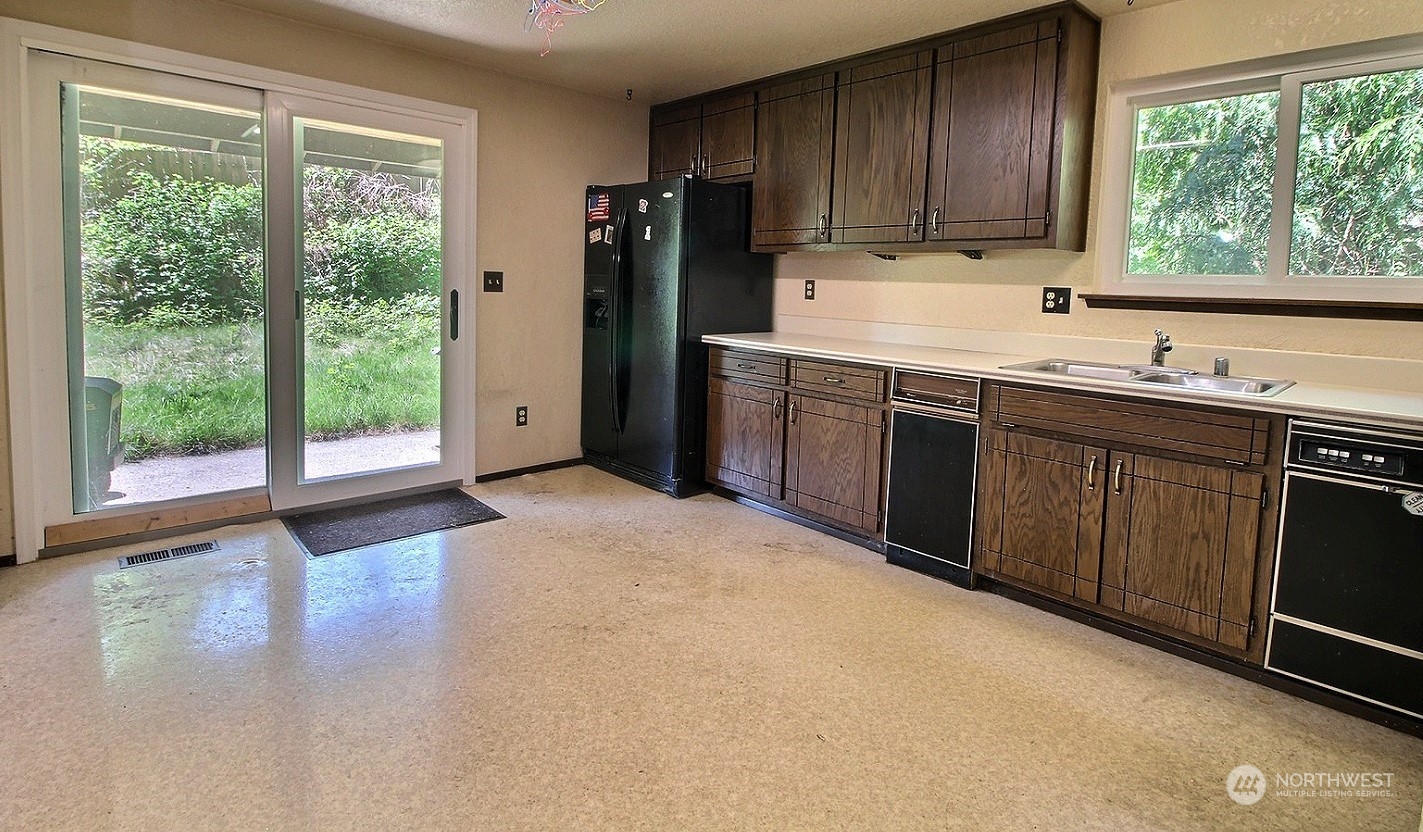 21123 West Richmond Road Bothell, WA 98021 - Photo 8 of 29 a kitchen with a sink window and cabinets