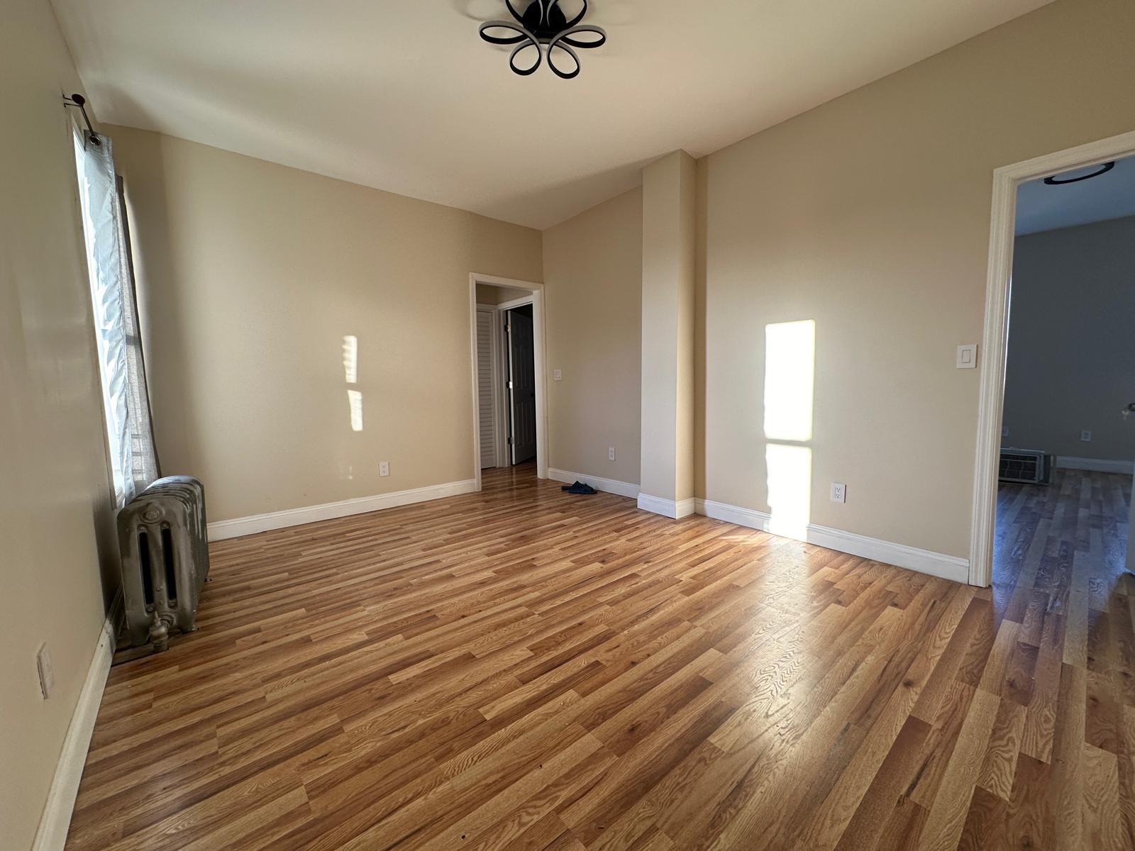 a view of a livingroom with a hardwood floor and a ceiling fan