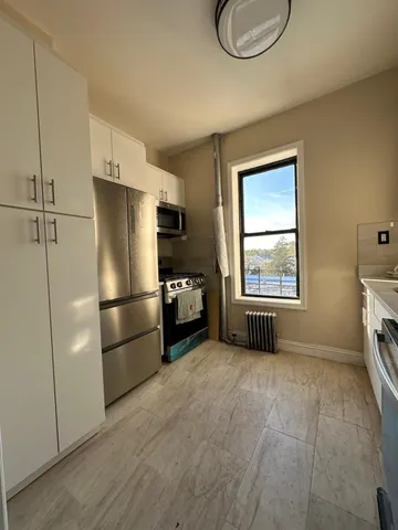 a kitchen with a refrigerator a stove a washer and dryer