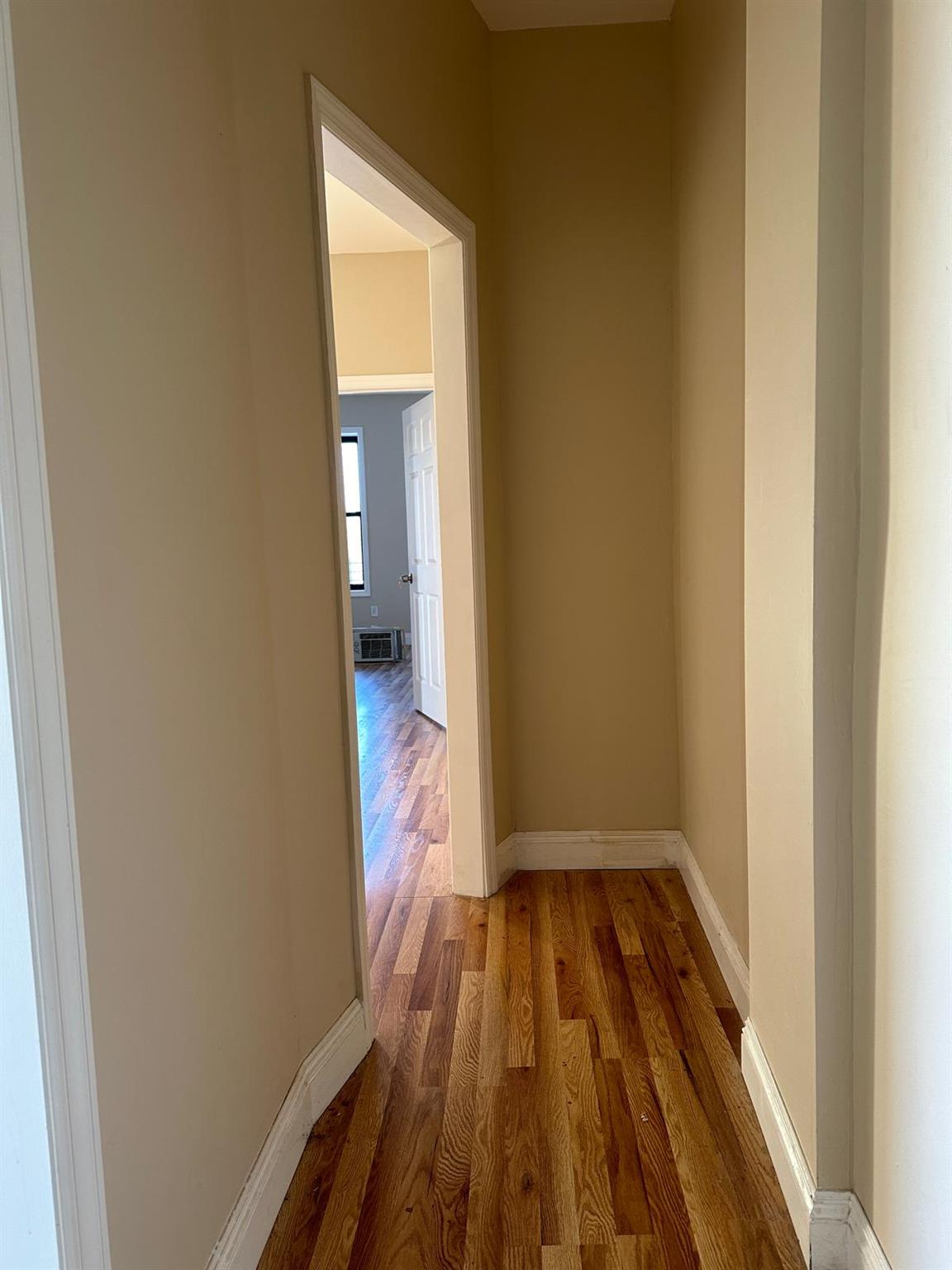 97-52 75th Street Queens, NY 11416 - Photo 4 of 9 a view of a room with wooden floor and a bathroom