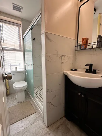 a bathroom with a toilet sink and mirror