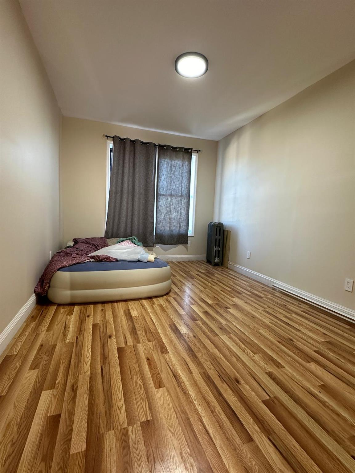 97-52 75th Street Queens, NY 11416 - Photo 8 of 9 a view of a room with wooden floor and chair