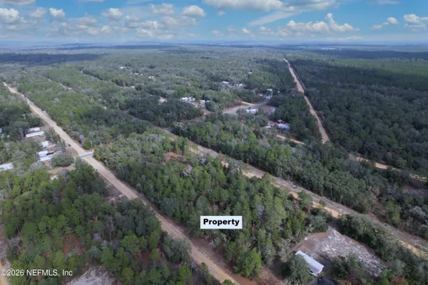 a bathroom with a glass shower door and a mirror
