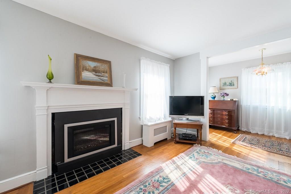 a living room with a fireplace furniture and a flat screen tv