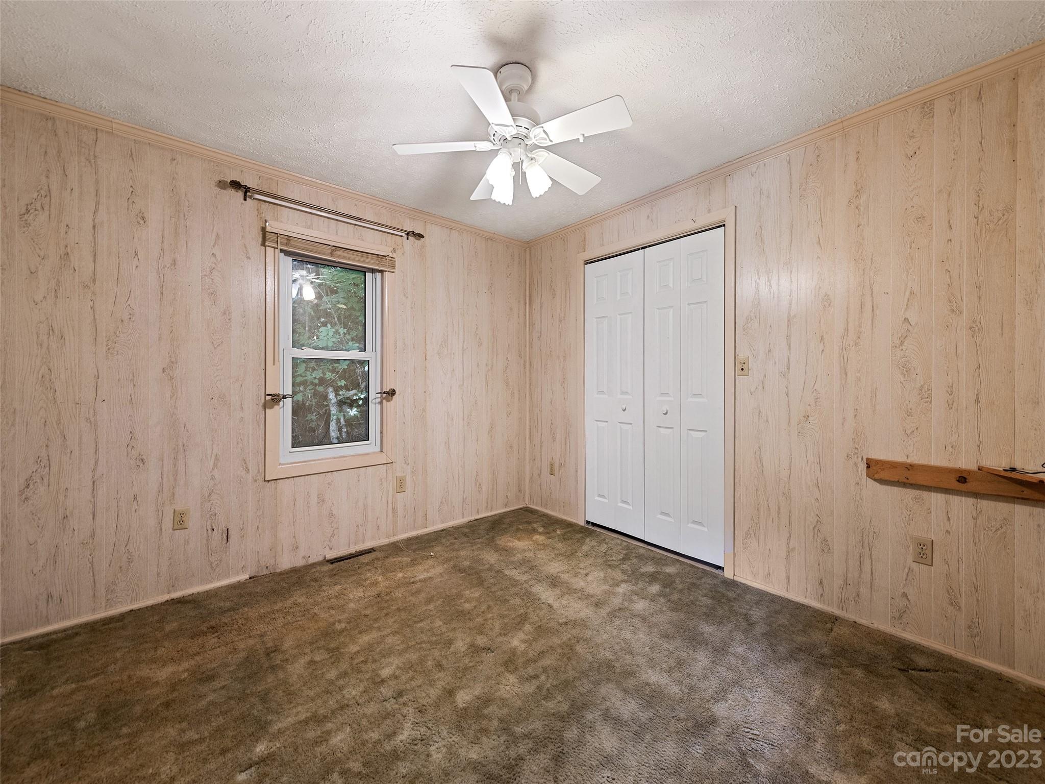 434 Red Bank Road Waynesville, NC 28786 - Photo 20 of 30 an empty room with windows and fan