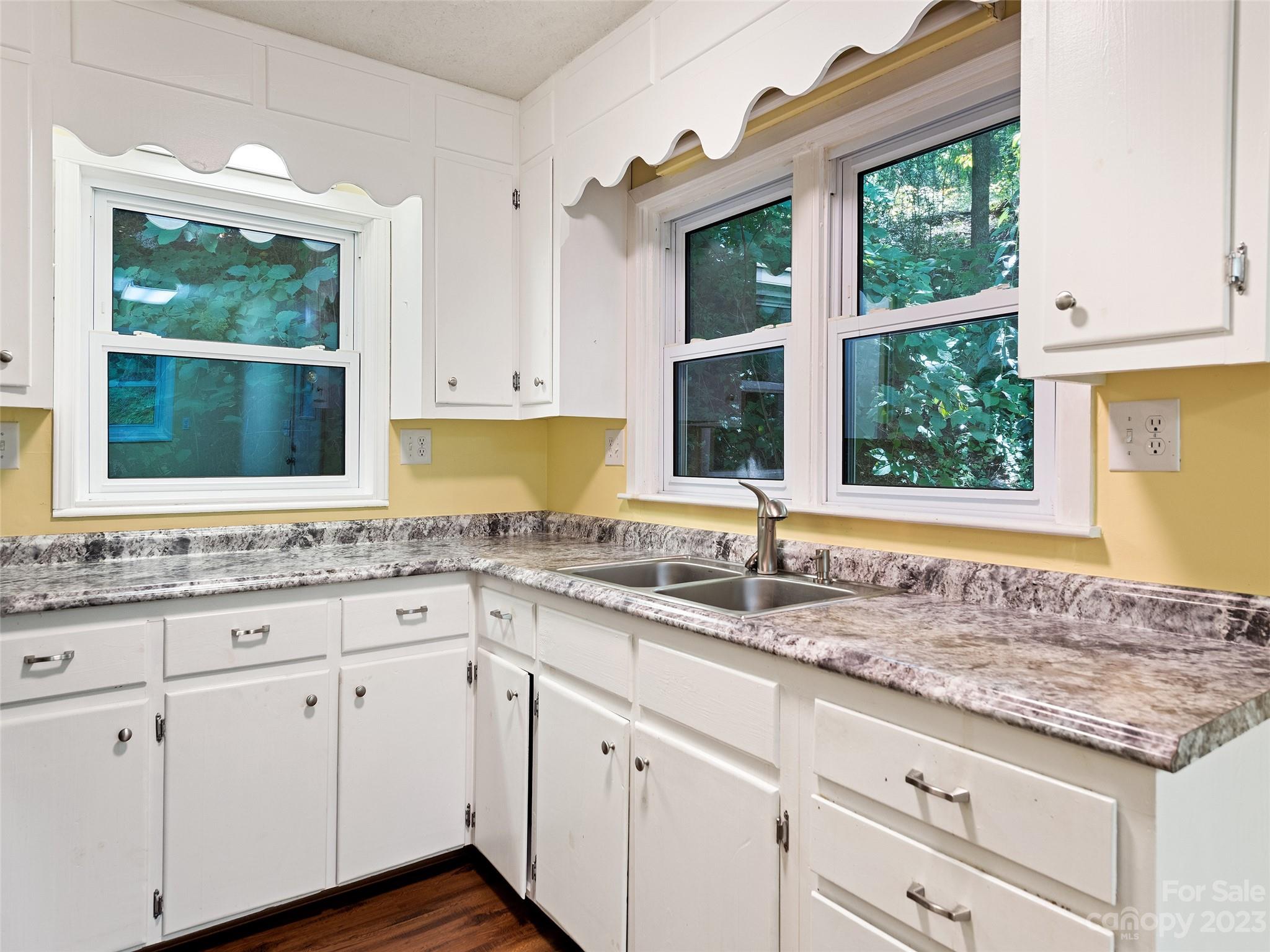 434 Red Bank Road Waynesville, NC 28786 - Photo 26 of 30 a kitchen with granite countertop a sink window and cabinets