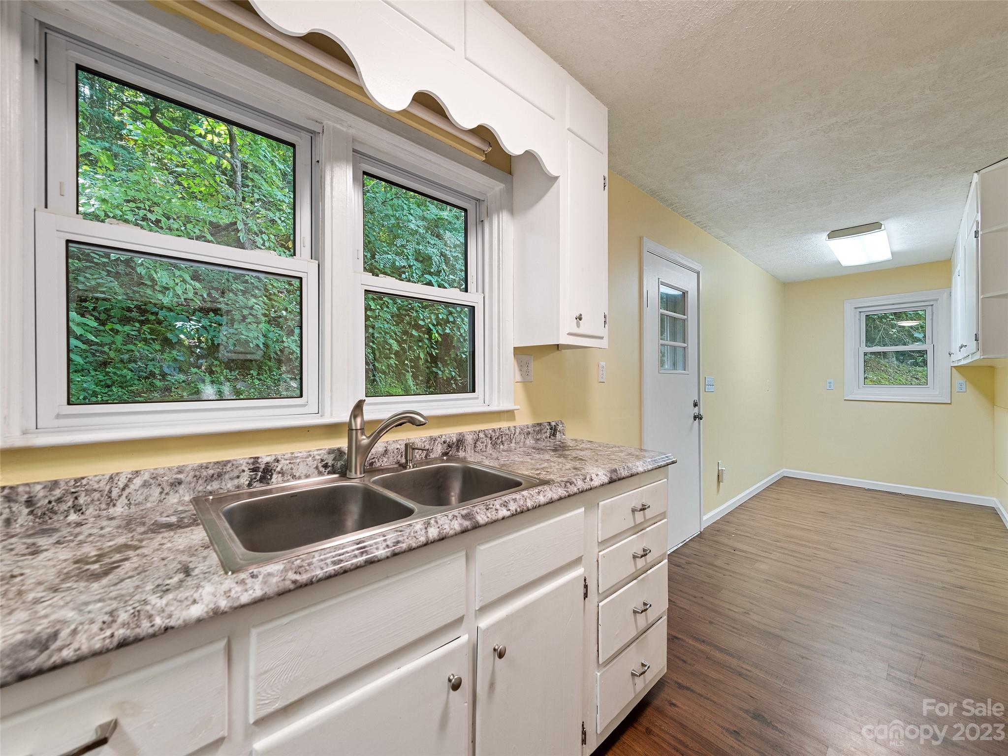 434 Red Bank Road Waynesville, NC 28786 - Photo 27 of 30 a kitchen with granite countertop a sink and a window