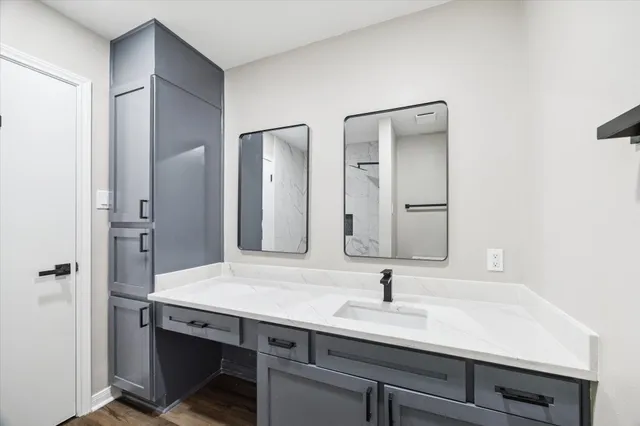 a bathroom with a sink and a mirror