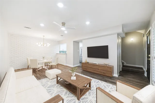 a living room with couches and a flat screen tv