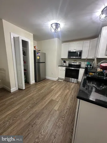 a kitchen with stainless steel appliances a refrigerator sink and stove