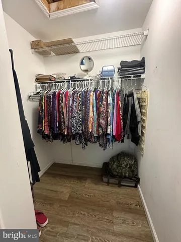 a view of walk in closet with clothes