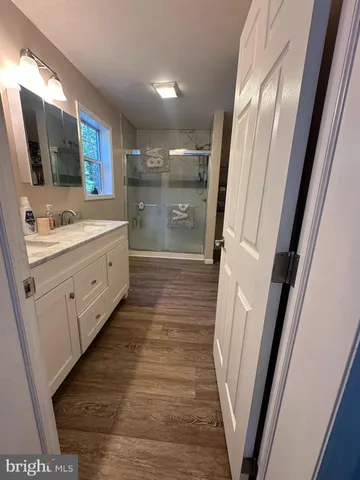 a bathroom with a double vanity sink and mirror