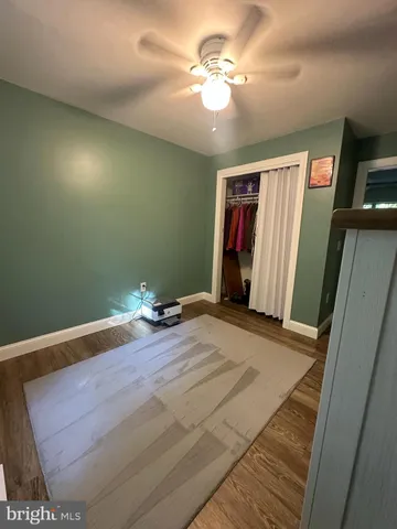 a view of empty room with window and ceiling fan