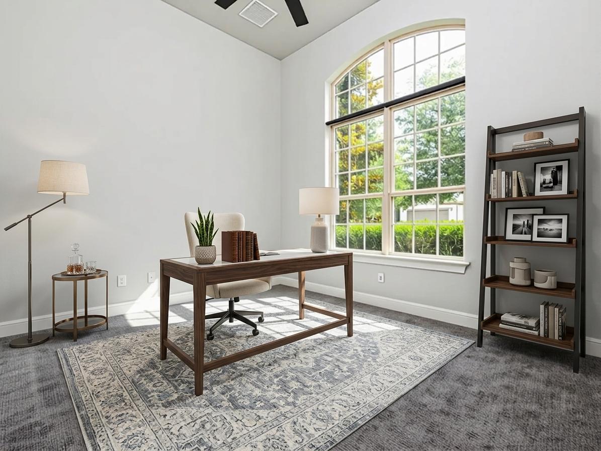1329 Siena Sunset Road Leander, TX 78641 - Photo 7 of 40 Natural light floods this home office through a grand arched window, creating an inspiring workspace.