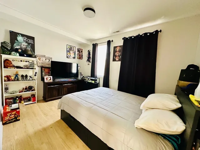 a bedroom with a bed and a flat screen tv