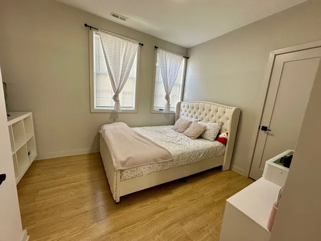 a bedroom with a bed and a window