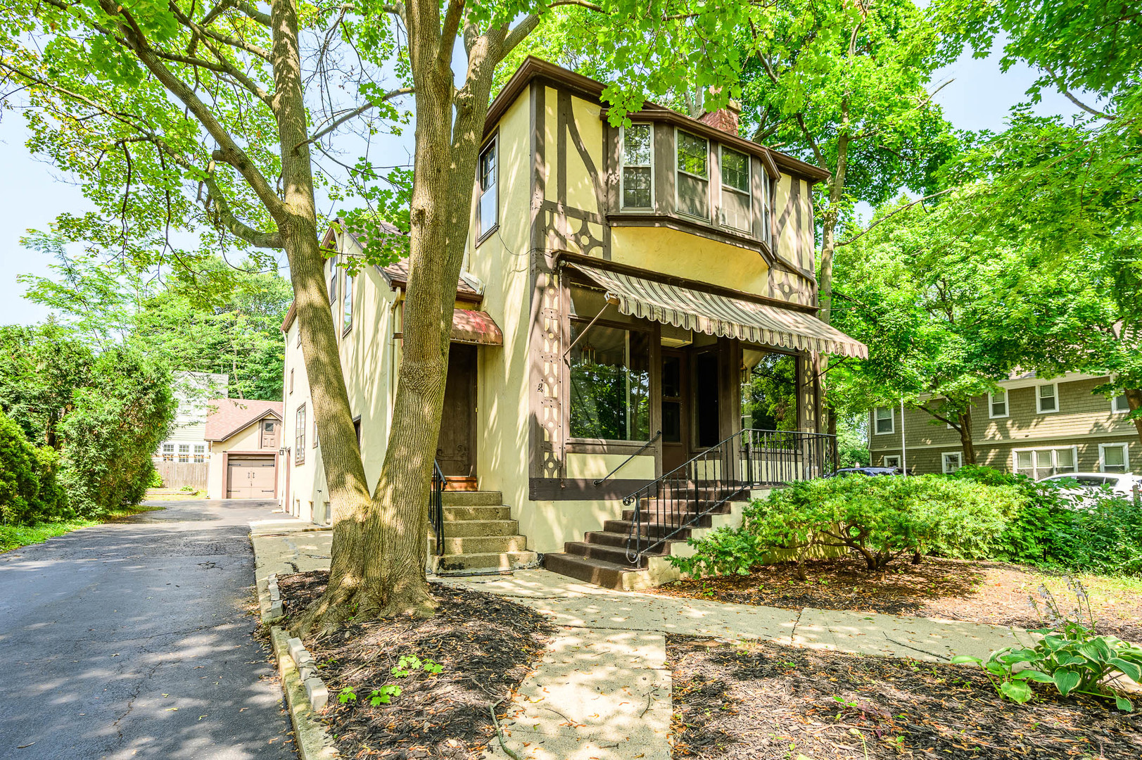 front view of a house with a tree in front