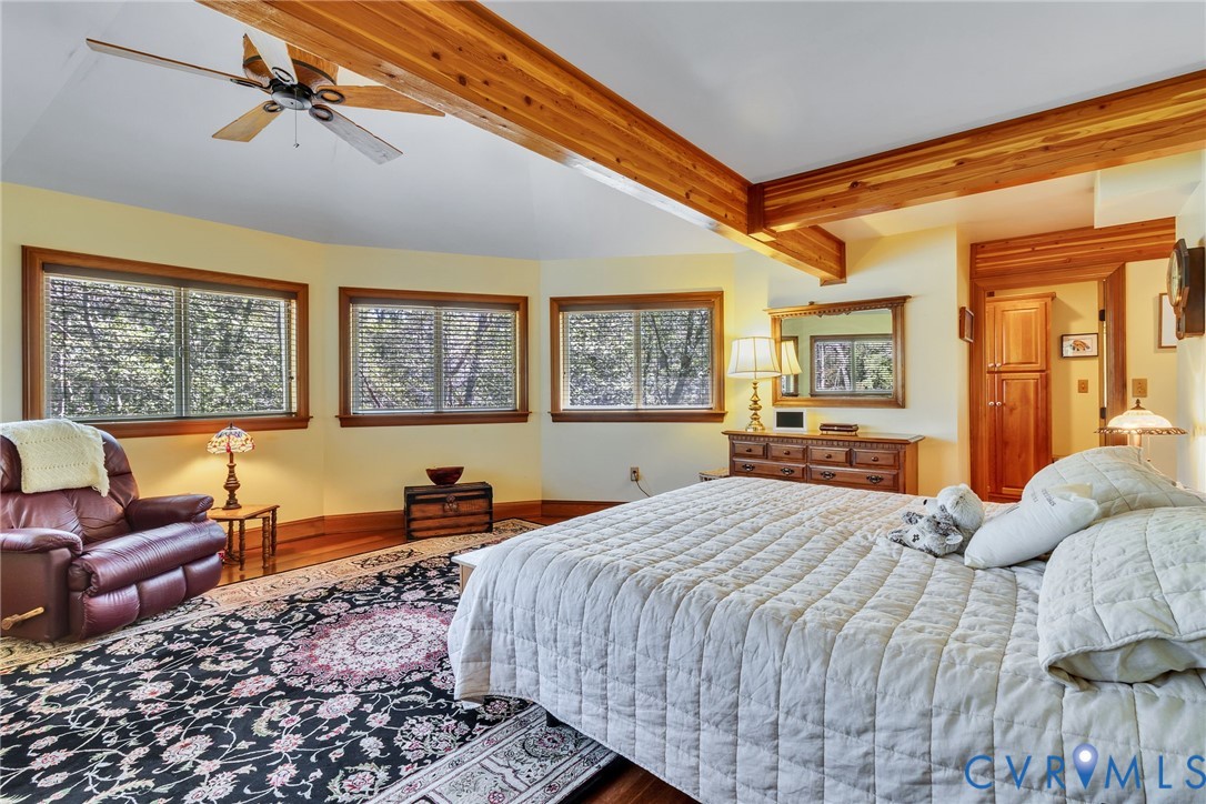 176 Baypointe Court Reedville, VA 22539 - Photo 38 of 60 a bedroom with a bed a couch and large window