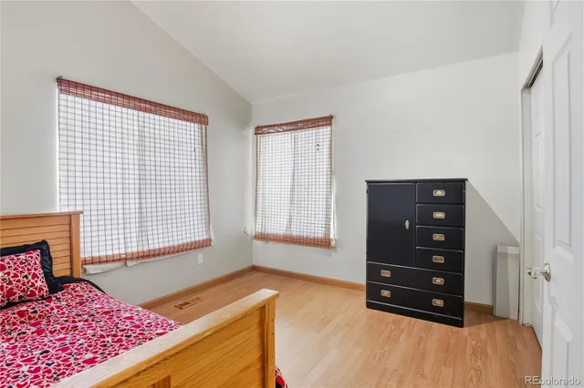 a bedroom with a bed and a tv on the dresser