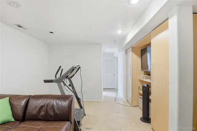 a living room with furniture and a ceiling fan