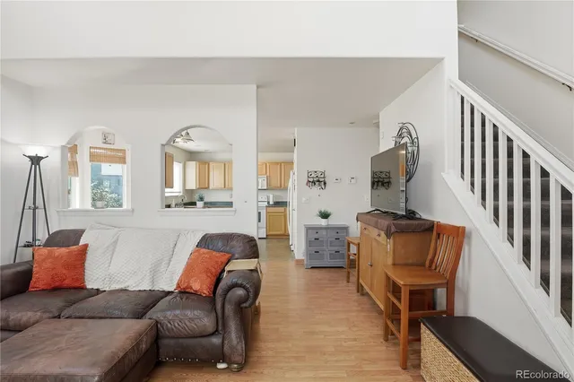 a living room with furniture and wooden floor
