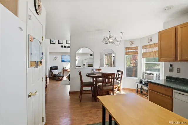 a view of a a dining room with furniture window and wooden floor