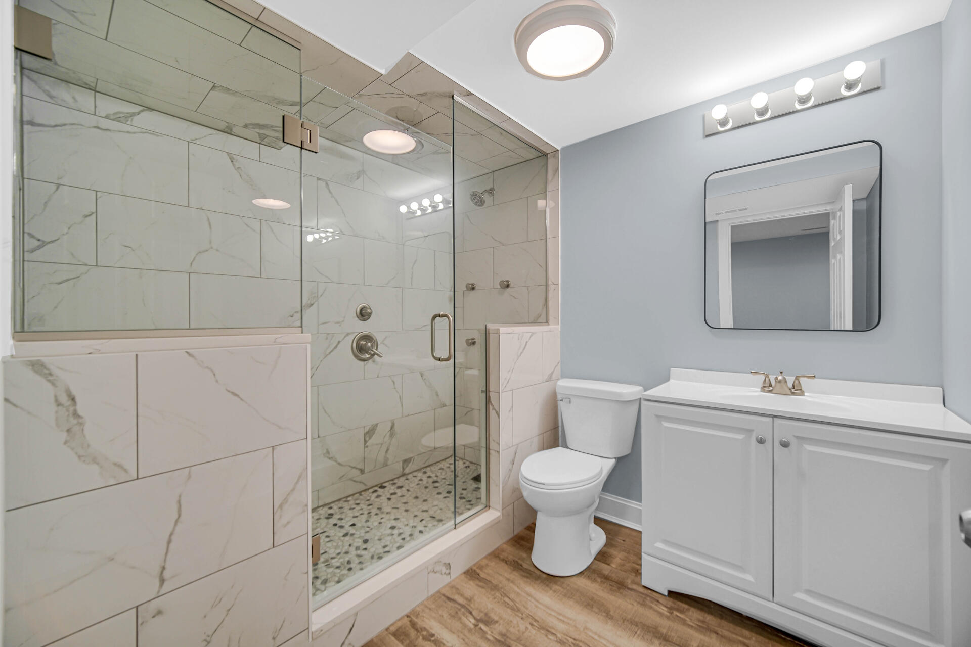 7428 East 120th Avenue Crown Point, IN 46307 - Photo 25 of 28 a bathroom with a toilet sink a mirror and shower