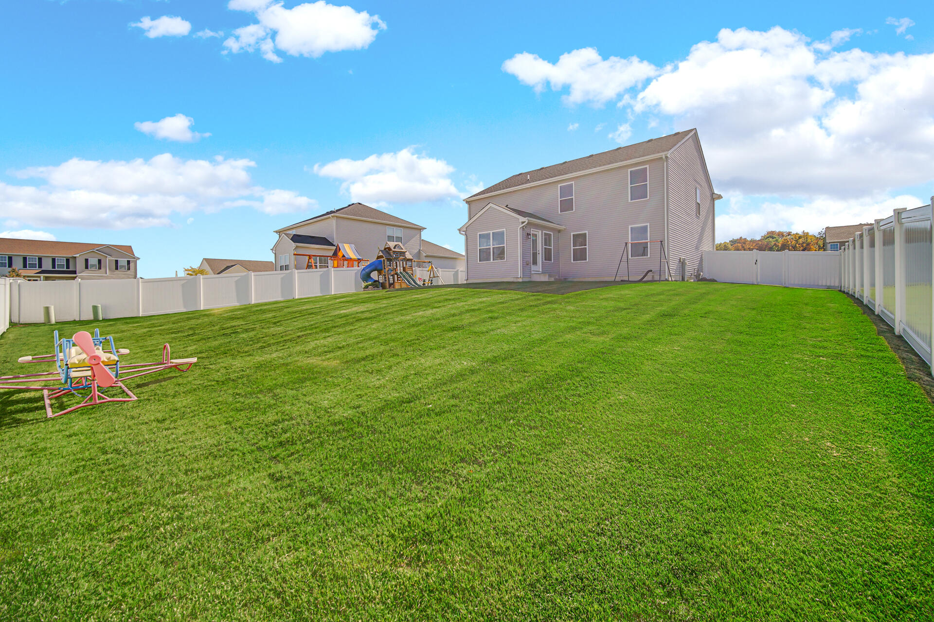 7428 East 120th Avenue Crown Point, IN 46307 - Photo 27 of 28 a view of a big house with a big yard and large trees