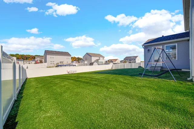 a view of a house with a backyard and a garden
