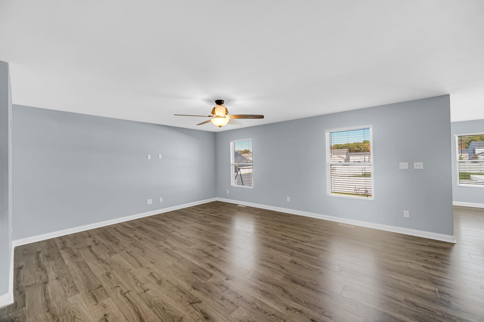 7428 East 120th Avenue Crown Point, IN 46307 - Photo 6 of 28 an empty room with wooden floor and windows