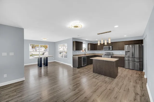 a kitchen with a sink cabinets and wooden floor
