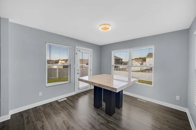 a room with wooden floor and windows