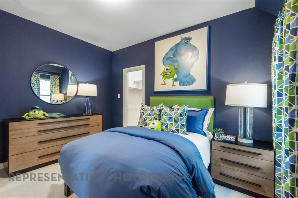 3909 Script Street Prosper, TX 75078 - Photo 15 of 25 a bedroom with a bed lamps and wooden floor