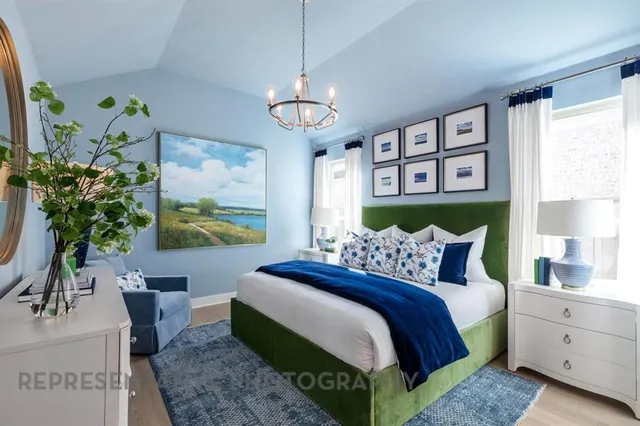 a bedroom with a bed and a chandelier