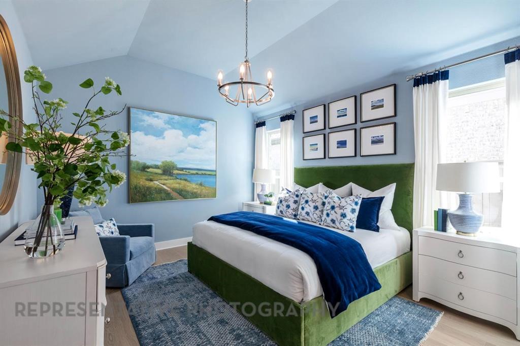 3909 Script Street Prosper, TX 75078 - Photo 7 of 25 a bedroom with a bed and a chandelier