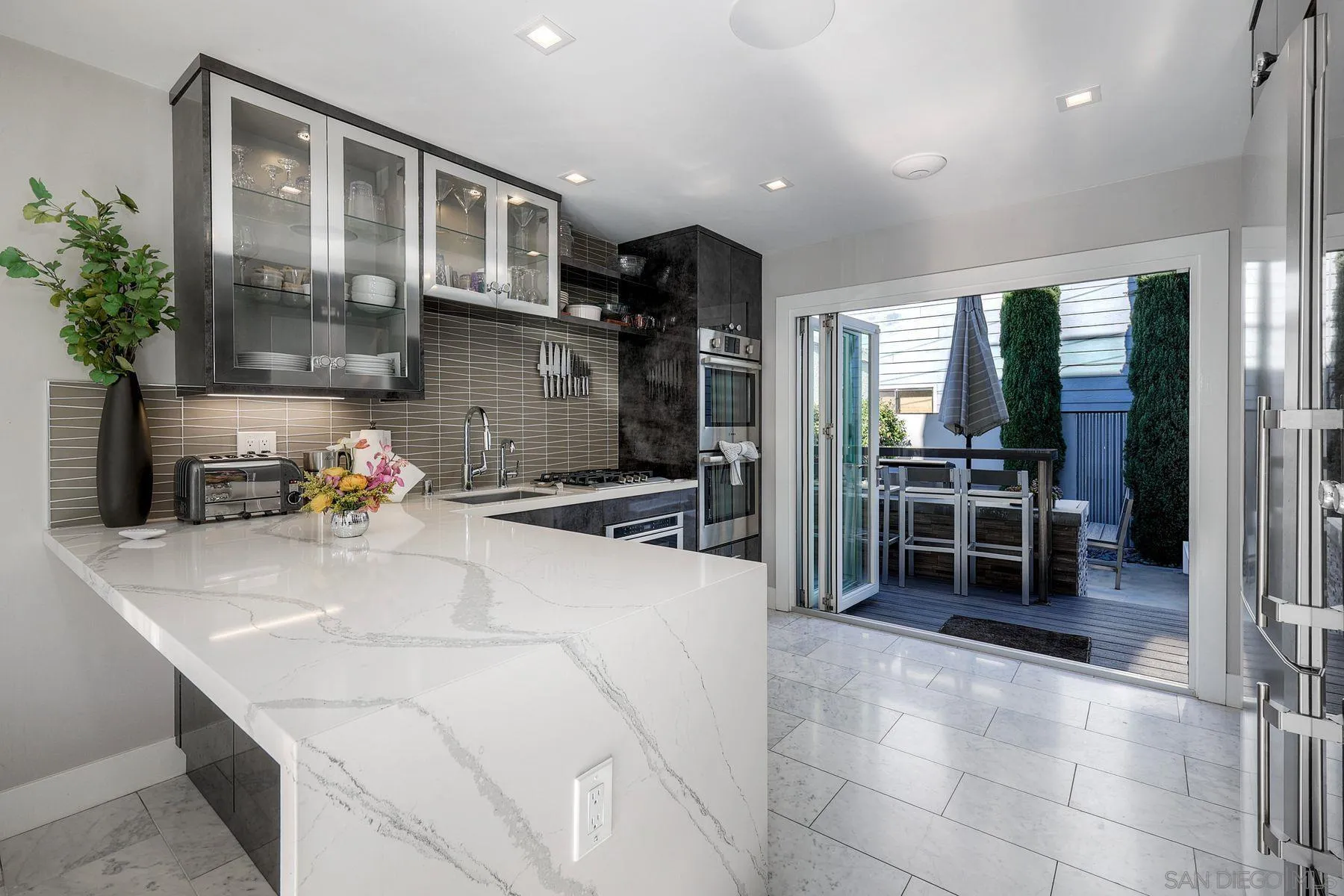 911 9th Street Coronado, CA 92118 - Photo 12 of 45 a kitchen with stainless steel appliances a sink and a refrigerator