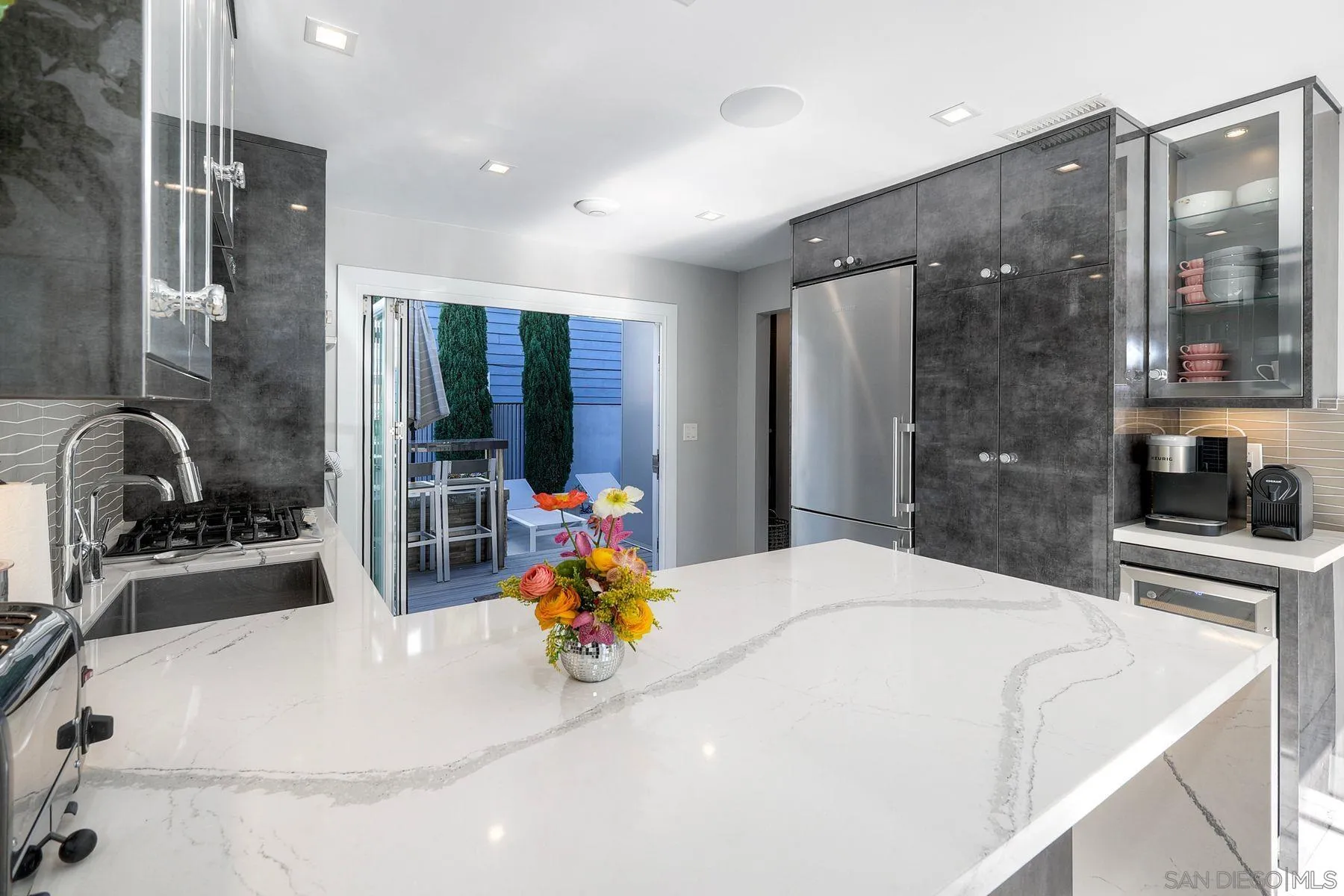 911 9th Street Coronado, CA 92118 - Photo 14 of 45 a kitchen with stainless steel appliances kitchen island granite countertop a sink and a refrigerator