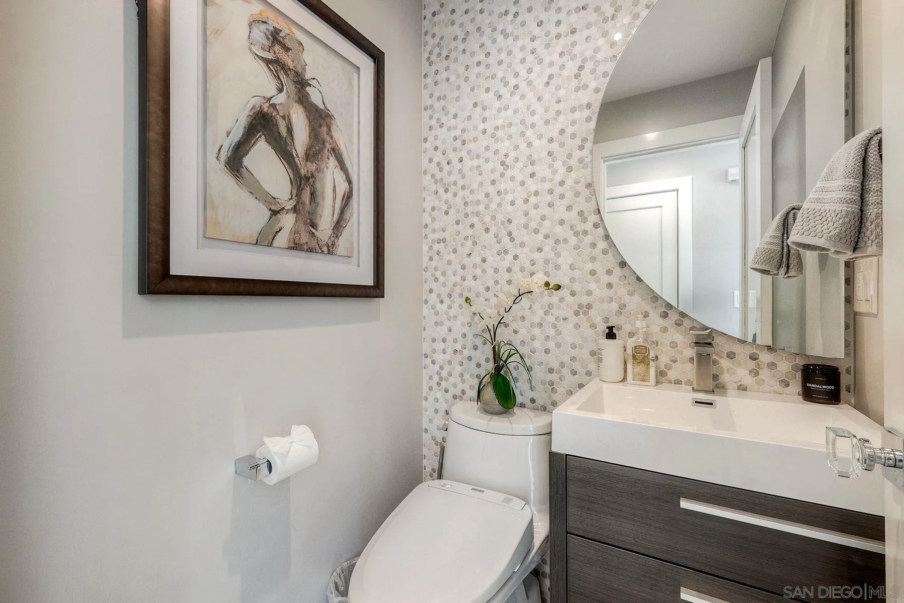 911 9th Street Coronado, CA 92118 - Photo 16 of 45 a bathroom with a toilet a sink and a mirror