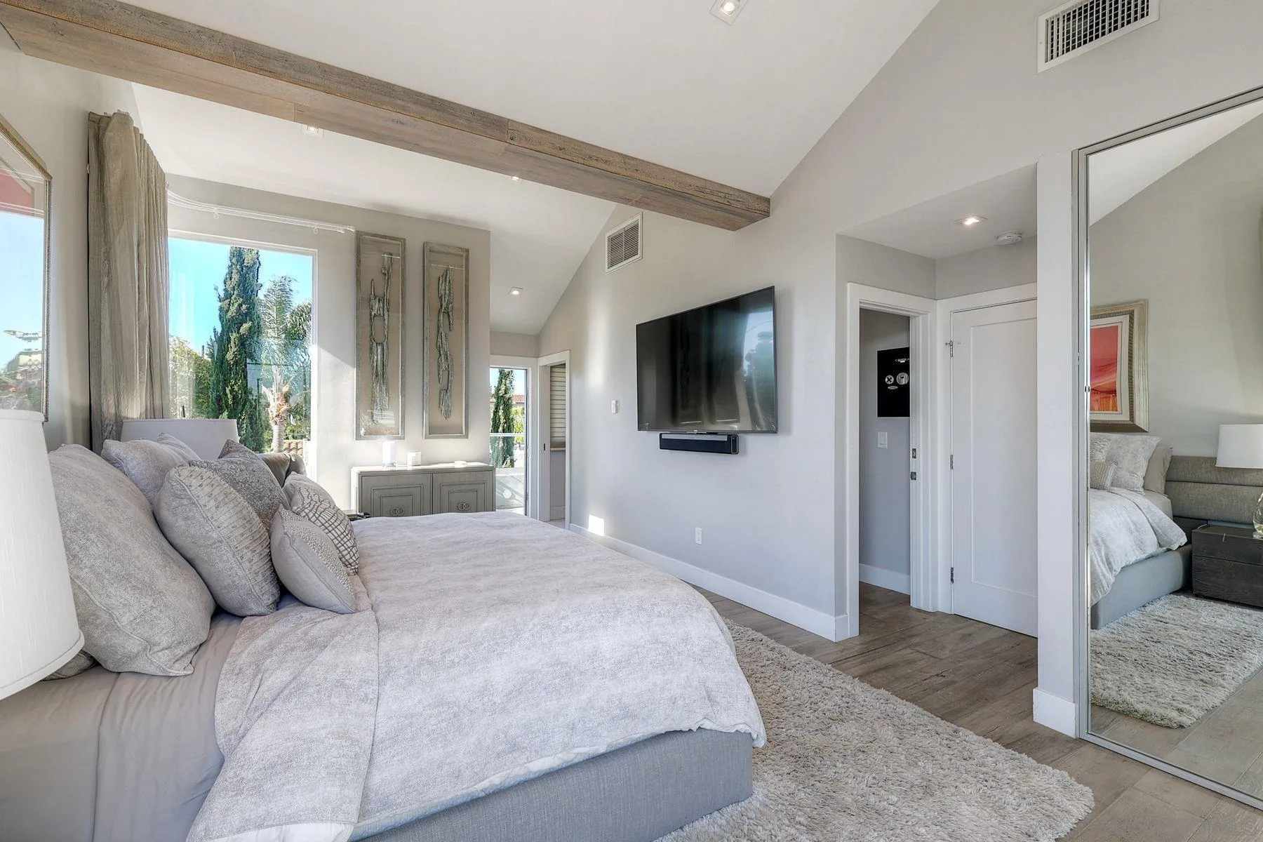 911 9th Street Coronado, CA 92118 - Photo 19 of 45 a bedroom with a large bed a flat tv screen and a view of living room